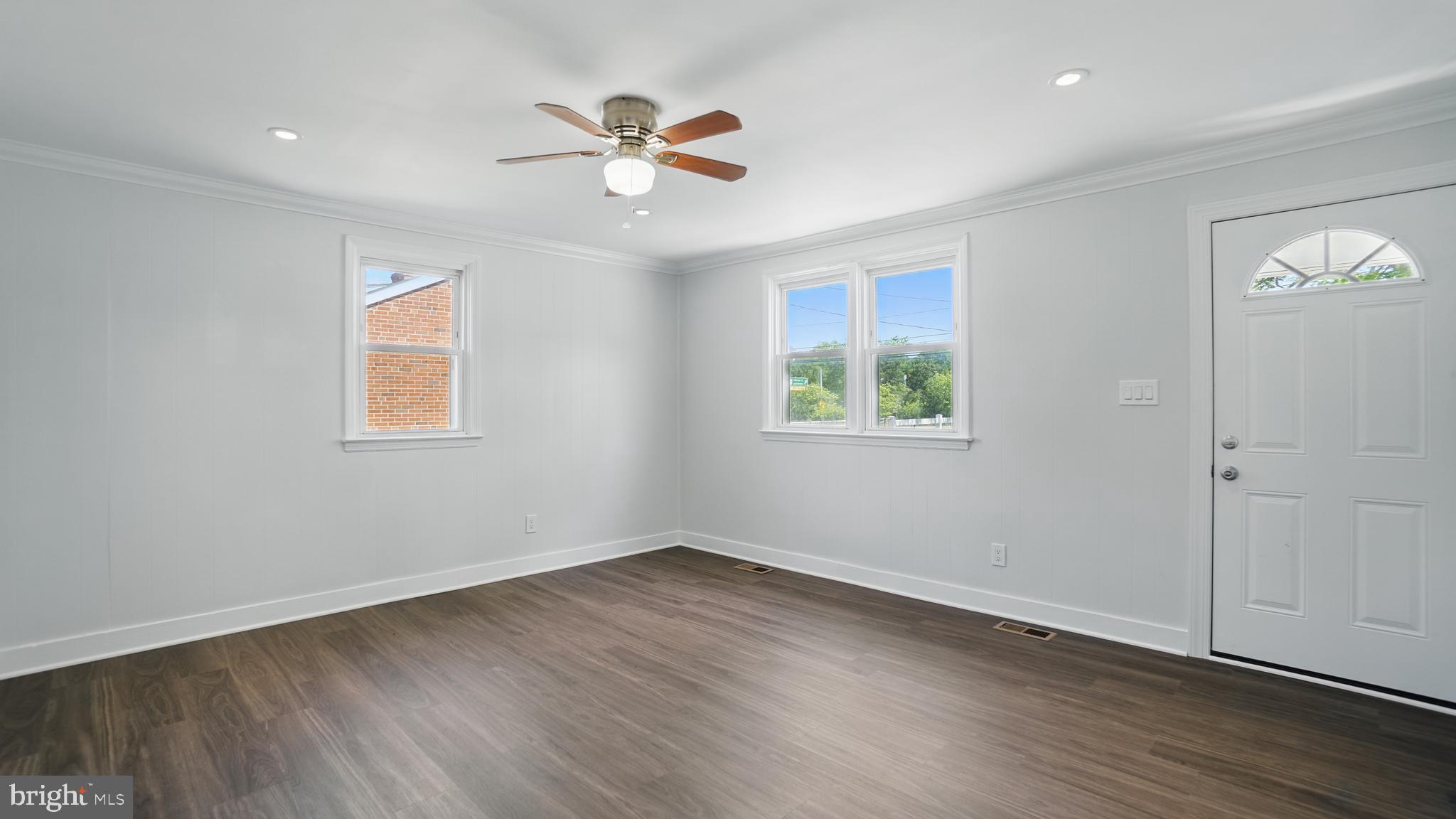 8014 Ritchie Highway Pasadena, MD 21122 - Photo 13 of 38 a view of empty room with wooden floor and fan