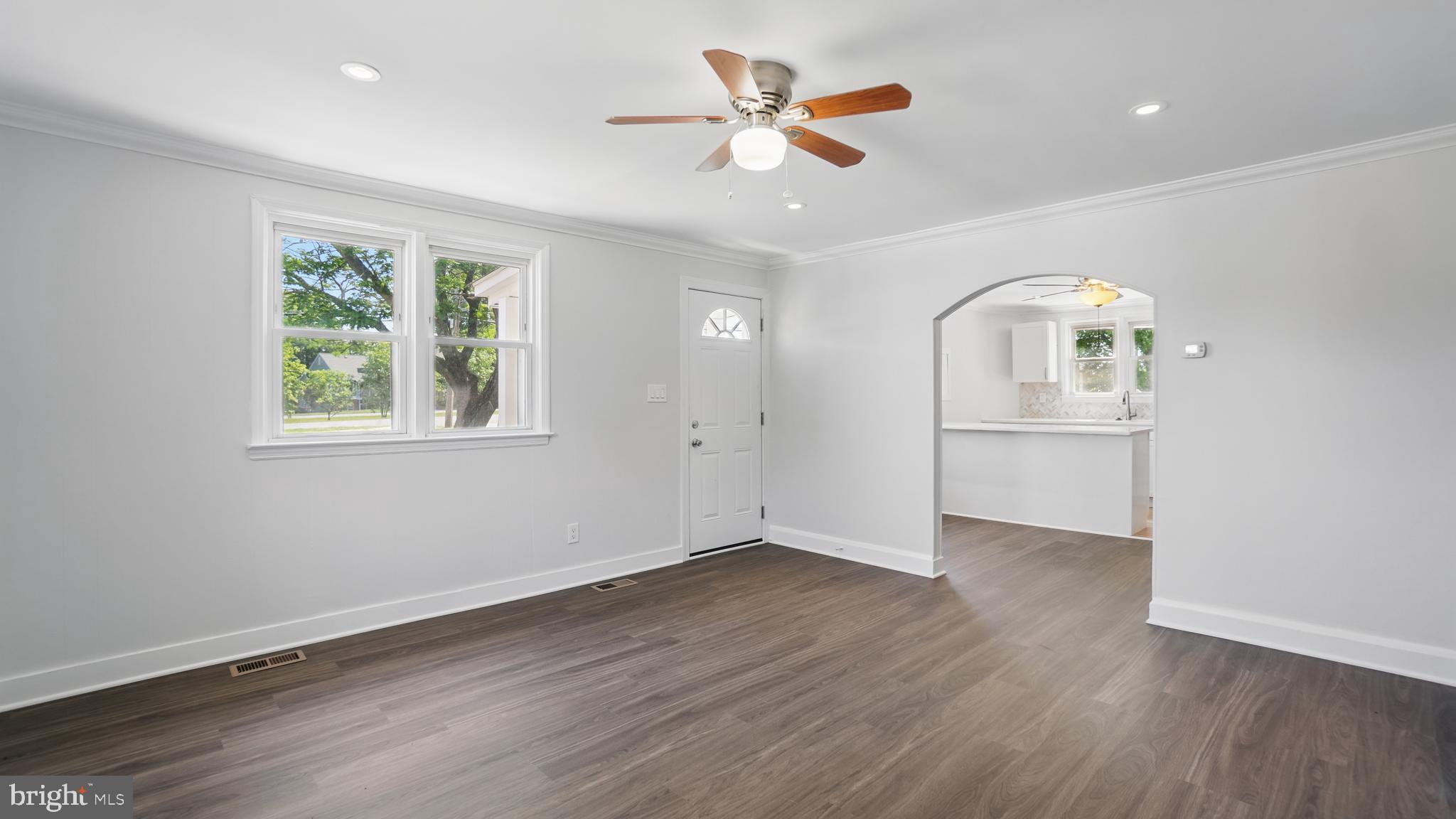 8014 Ritchie Highway Pasadena, MD 21122 - Photo 14 of 38 a view of an empty room with a window and wooden floor
