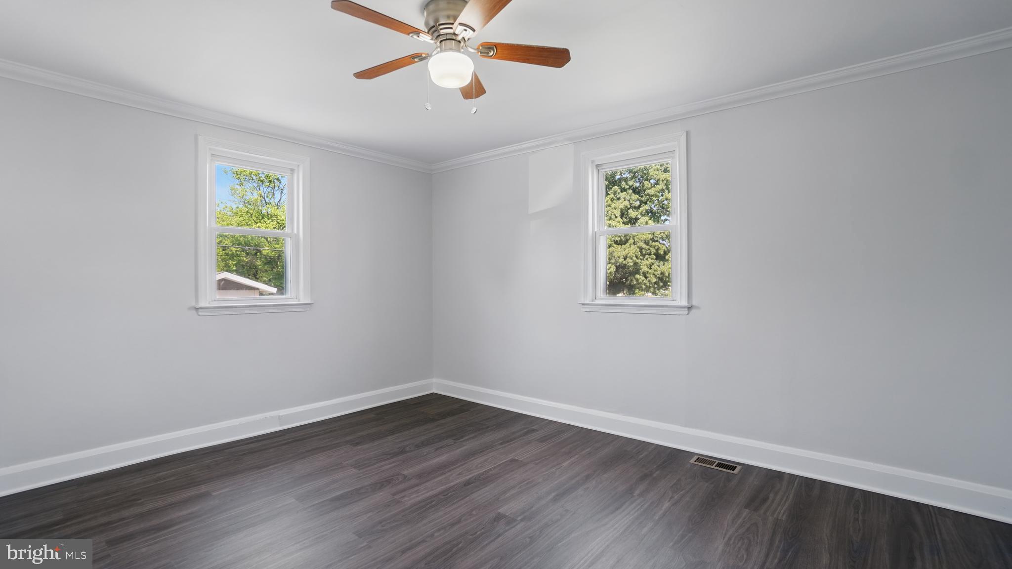 8014 Ritchie Highway Pasadena, MD 21122 - Photo 16 of 38 a view of an empty room with window and wooden floor