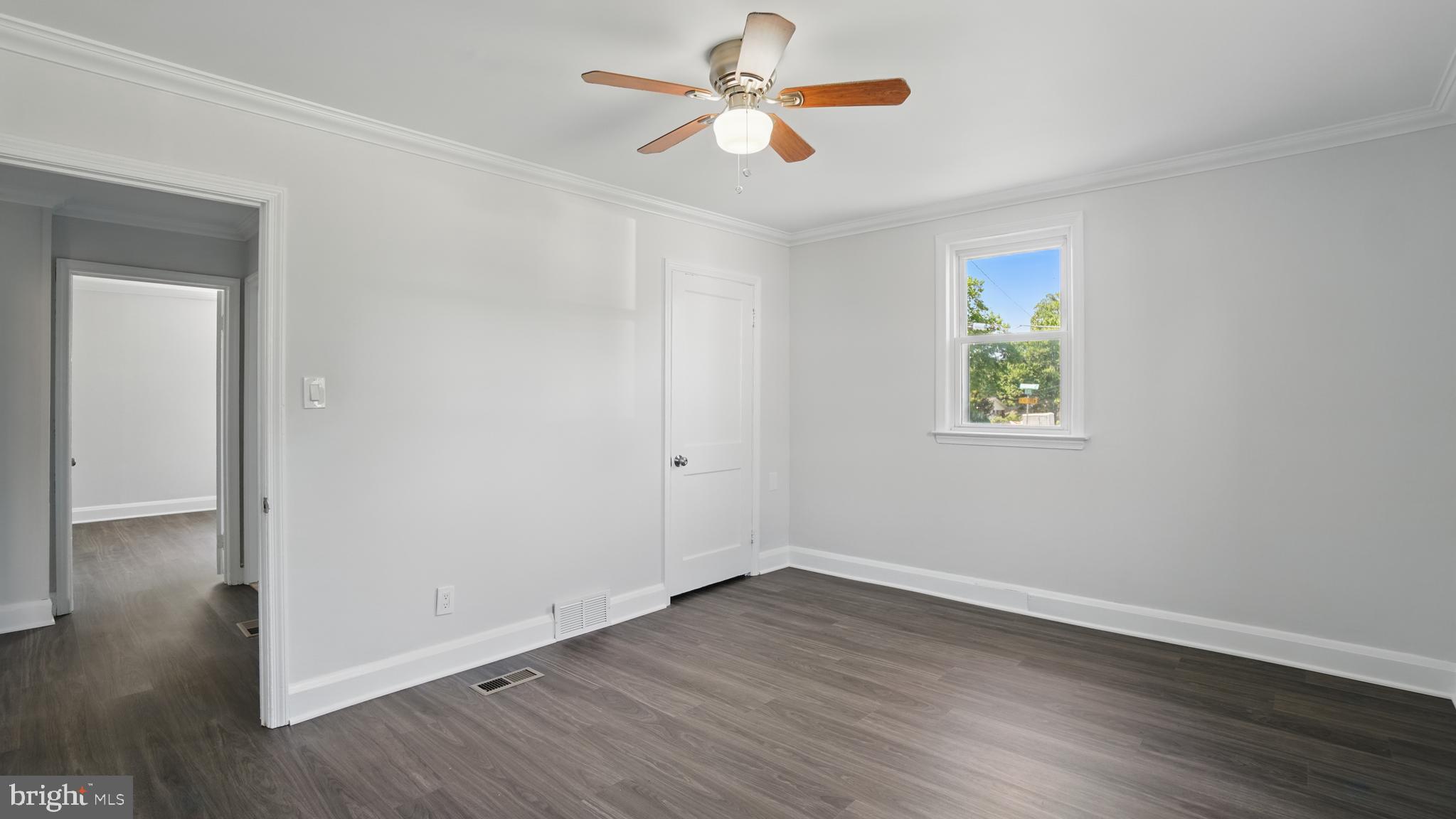 8014 Ritchie Highway Pasadena, MD 21122 - Photo 17 of 38 an empty room with wooden floor and ceiling fan