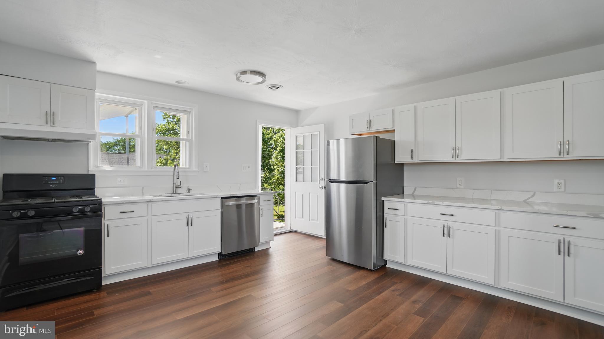 8014 Ritchie Highway Pasadena, MD 21122 - Photo 22 of 38 a kitchen with a refrigerator stove and wooden cabinets