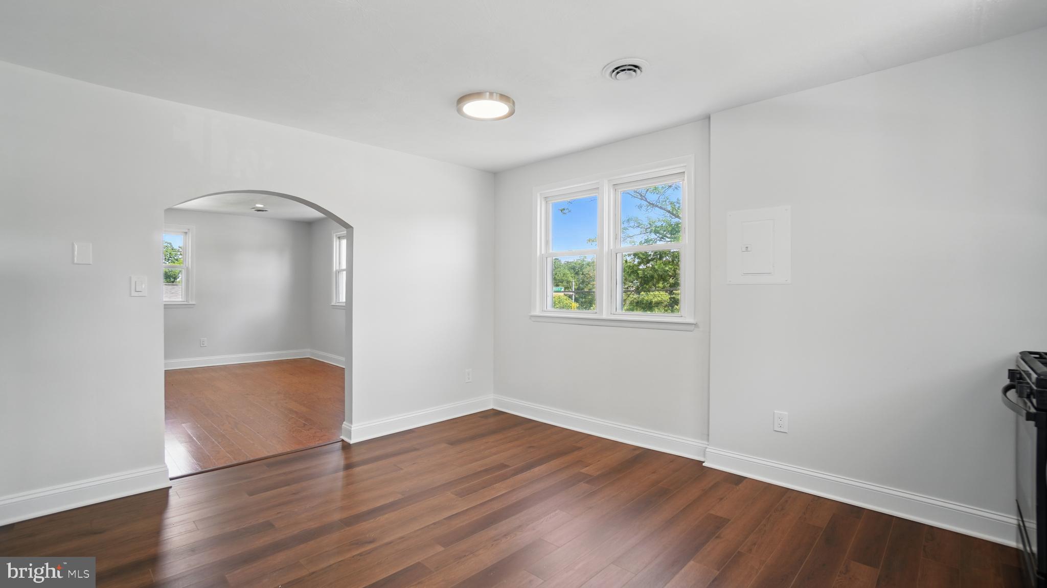 8014 Ritchie Highway Pasadena, MD 21122 - Photo 23 of 38 an empty room with wooden floor and windows