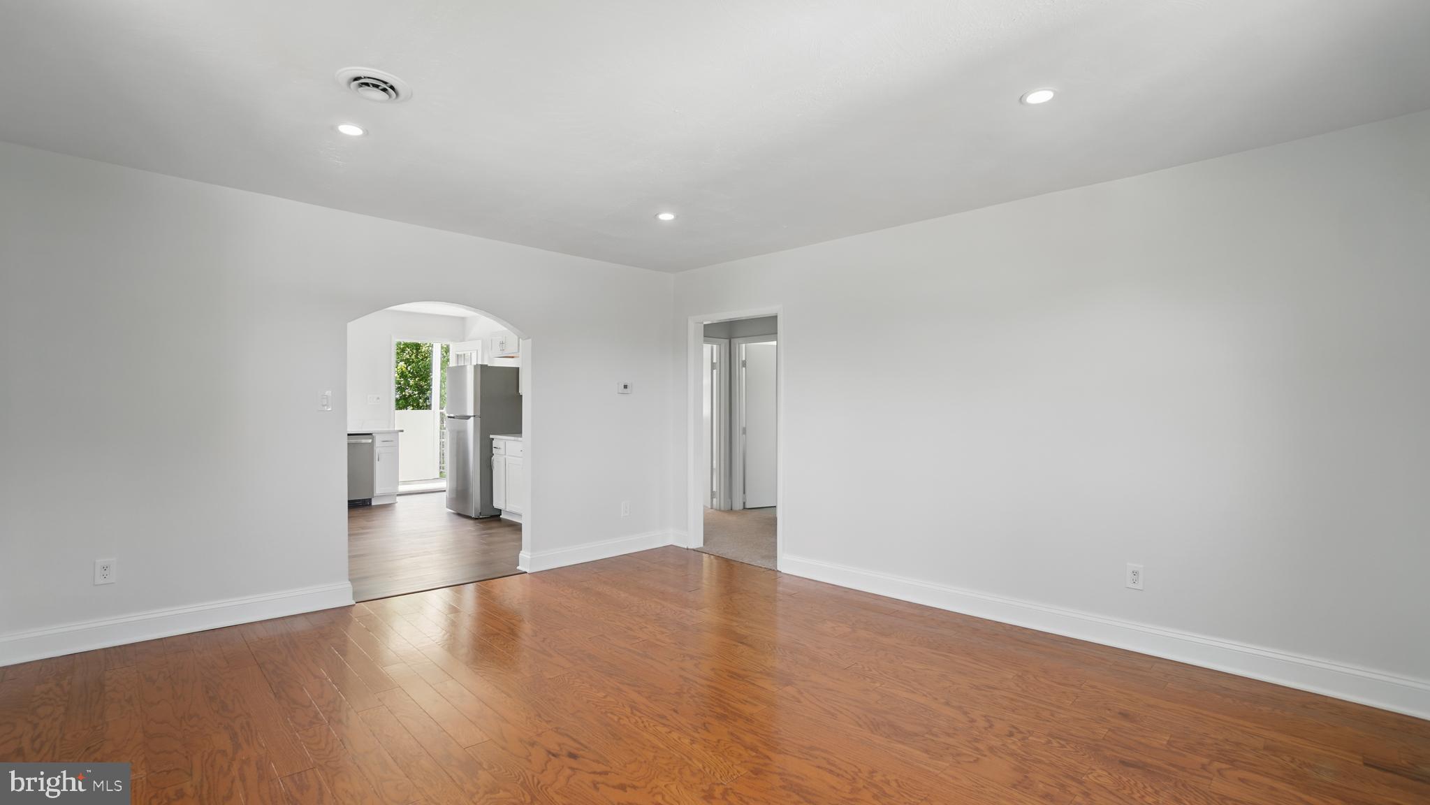 8014 Ritchie Highway Pasadena, MD 21122 - Photo 27 of 38 wooden floor in an empty room with a window