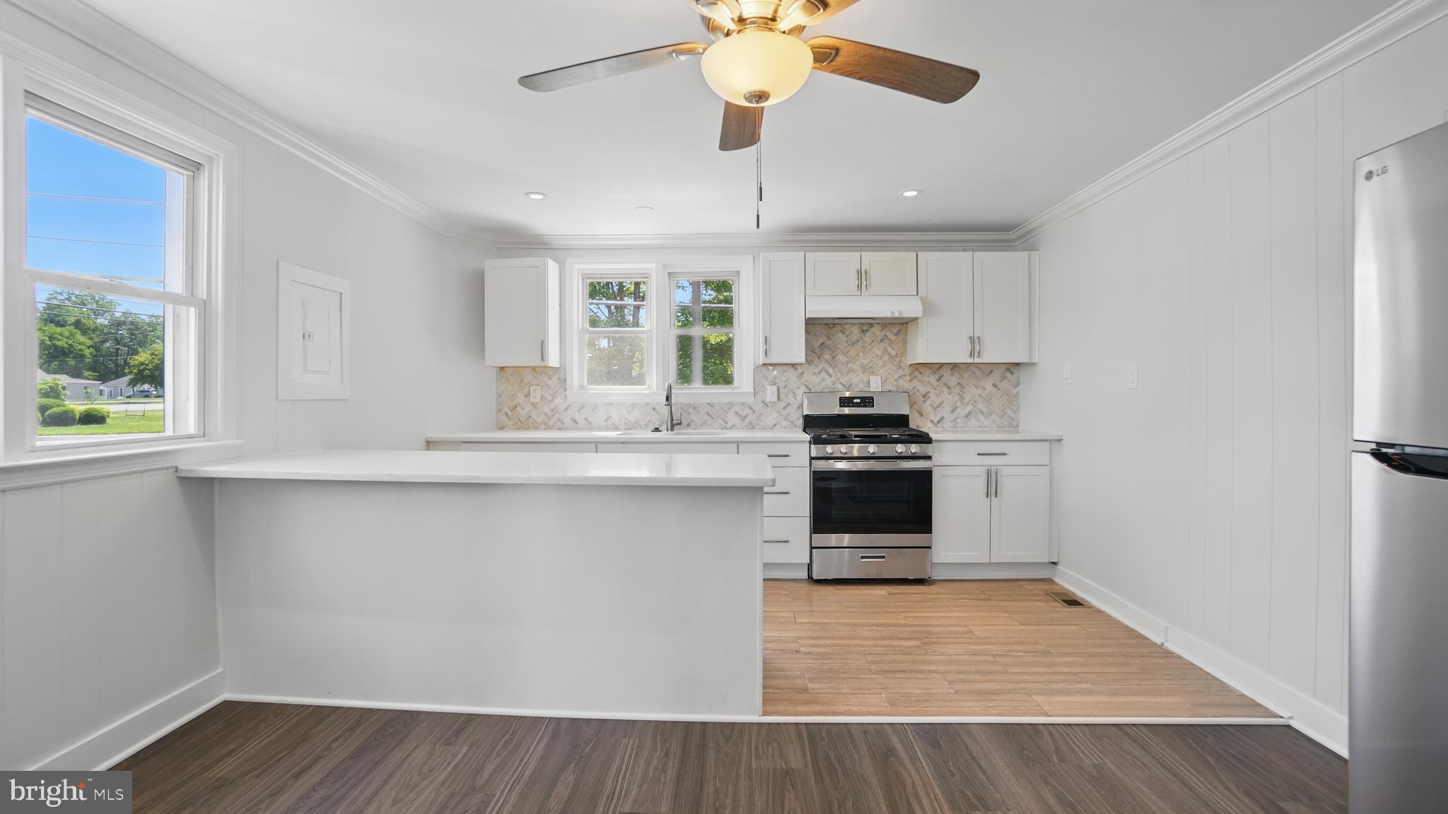 8014 Ritchie Highway Pasadena, MD 21122 - Photo 9 of 38 a kitchen with a sink a window and stainless steel appliances