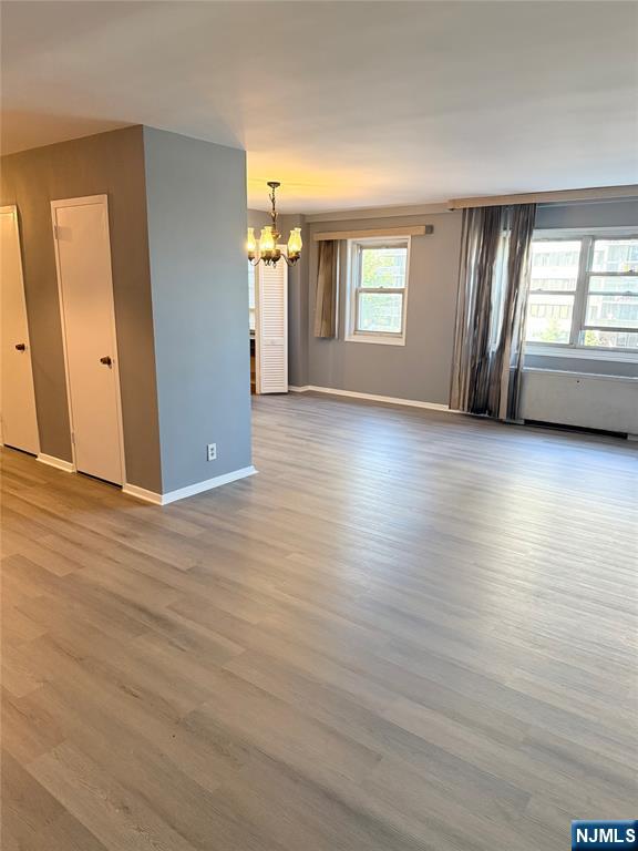 280 South Prospect Avenue, Unit 3N Hackensack, NJ 07601 - Photo 10 of 24 an empty room with wooden floor and windows