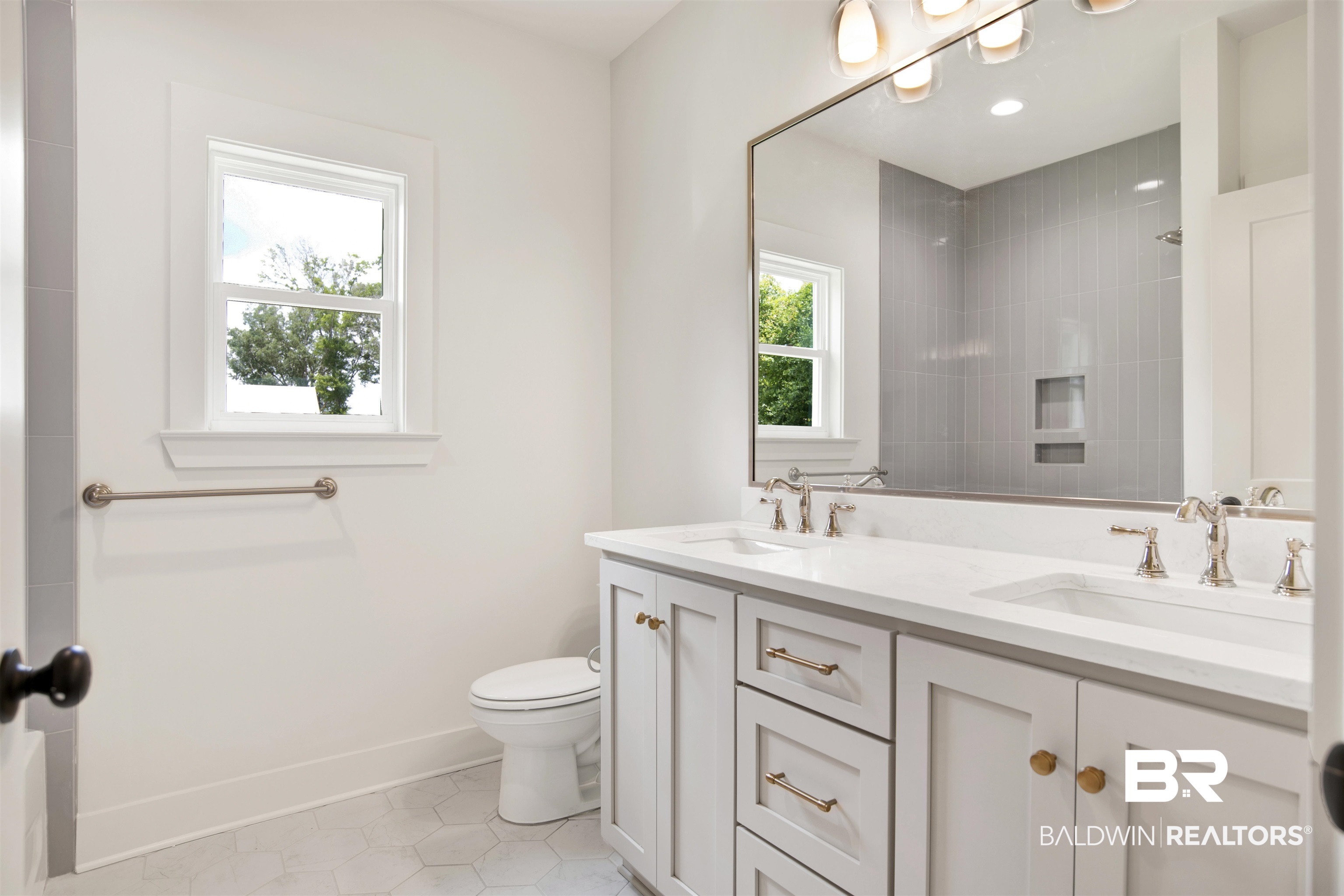 9275 Clarke Ridge Road Foley, AL 36535 - Photo 33 of 43 Bathroom with double vanity, tile patterned floors, toilet, a tile shower, and baseboards