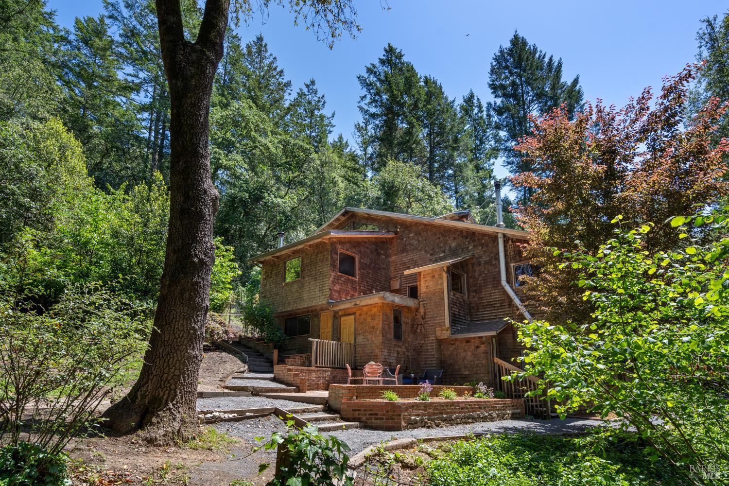 a front view of a house with yard and trees