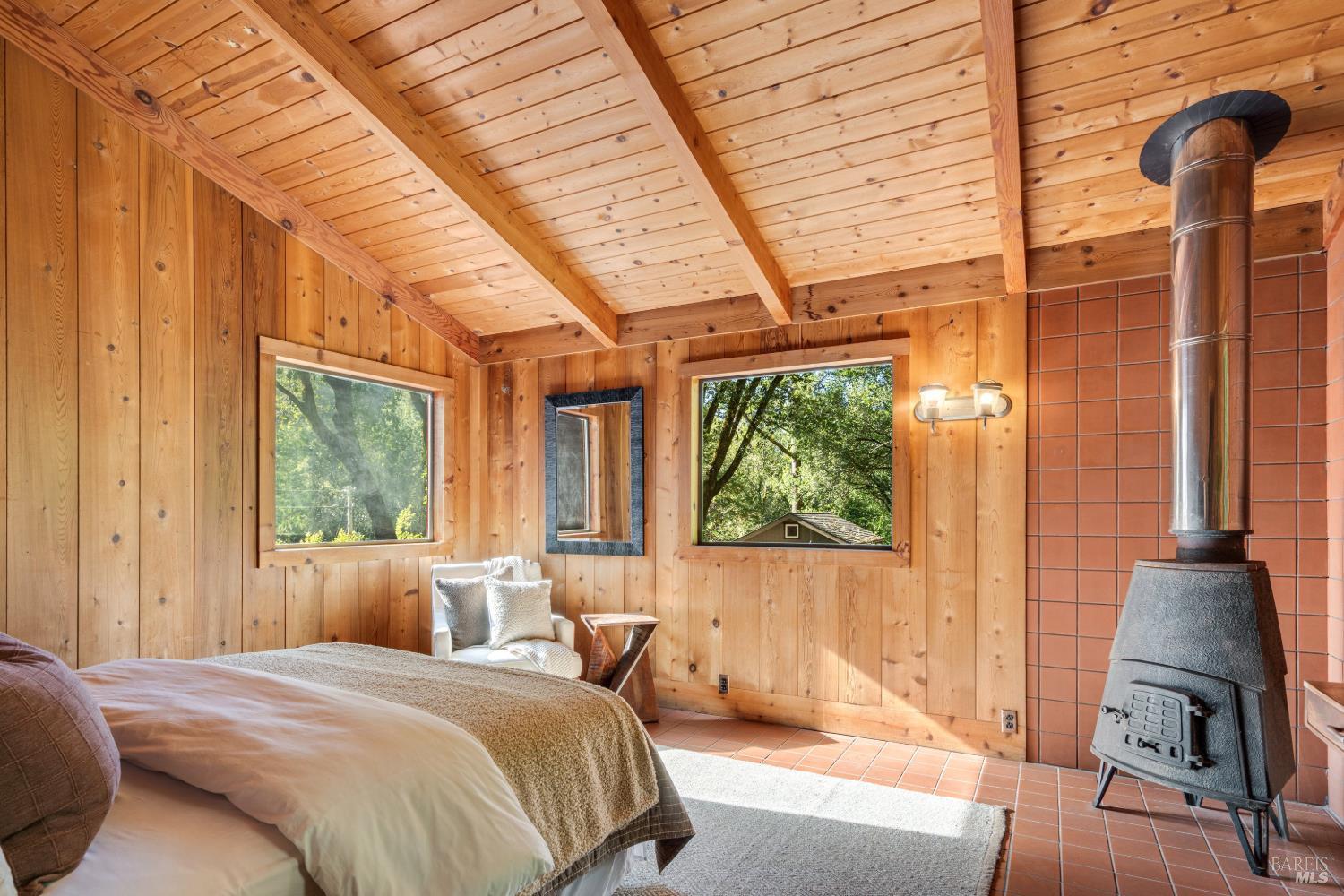 805 Wagnon Road Sebastopol, CA 95472 - Photo 32 of 56 a bedroom with a bed and large windows