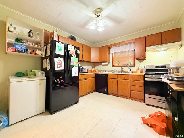 a kitchen with a stove a refrigerator and a sink