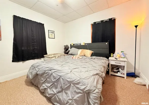 a bedroom with a bed and a television