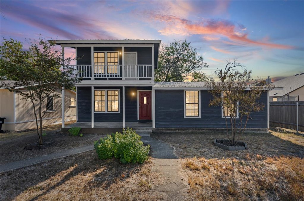 205 Cisneros Street Kyle, TX 78640 - Photo 1 of 17 View of front of house featuring a metal roof and a balcony