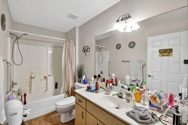 a bathroom with a sink vanity mirror and toilet