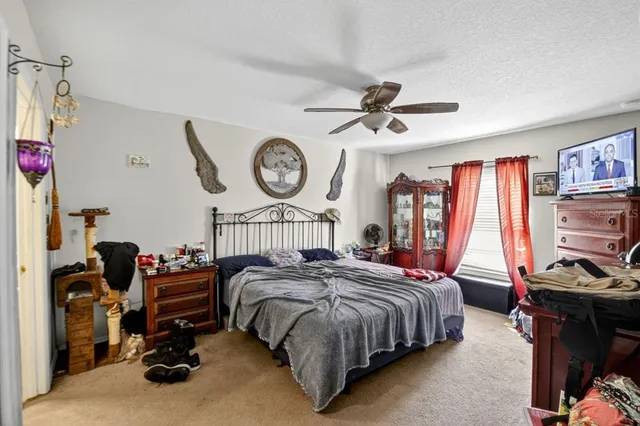 a bedroom with bed and a large window