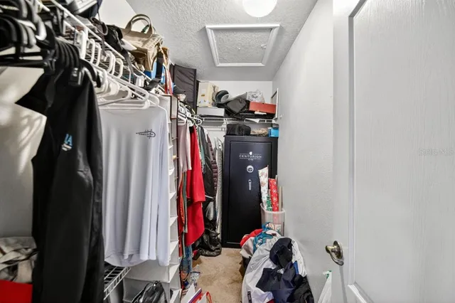 a view of walk in closet with clothes