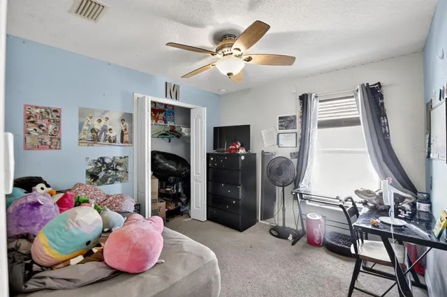 a bedroom with furniture and a flat screen tv