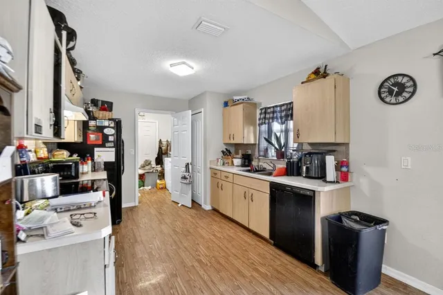a kitchen with stainless steel appliances a sink and cabinets