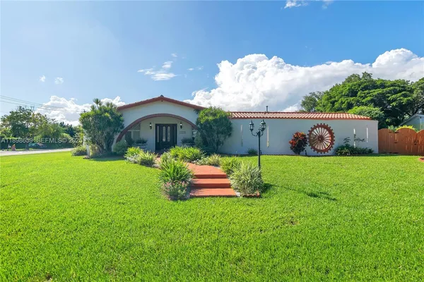 a front view of a house with garden
