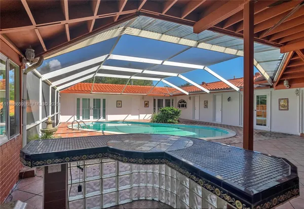 a backyard of a house with barbeque oven table and chairs
