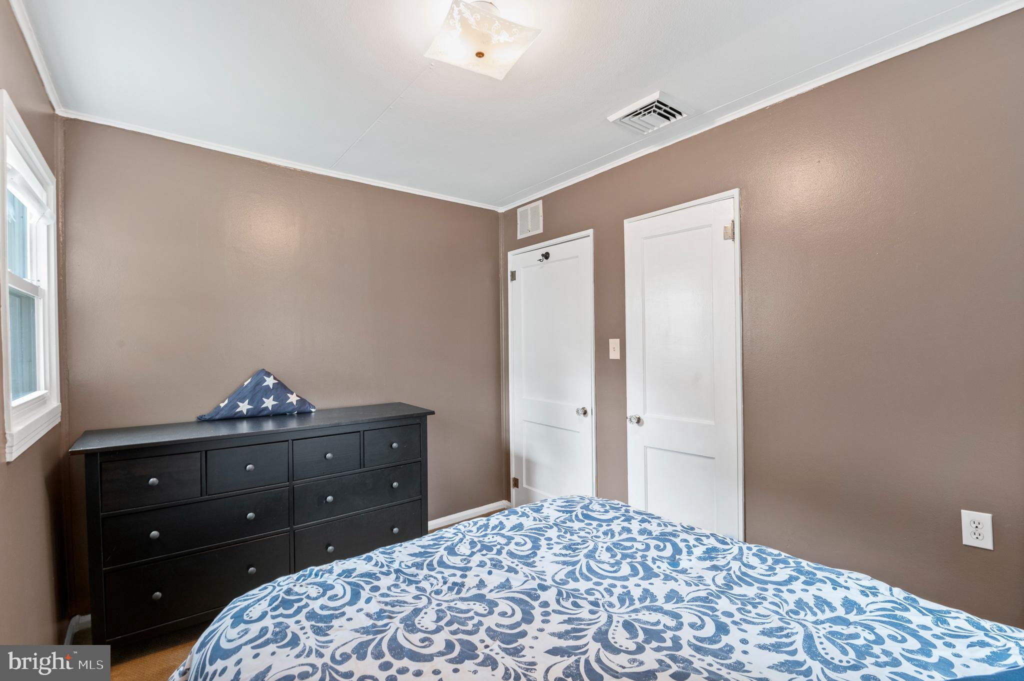 105 Manor Road Paoli, PA 19301 - Photo 17 of 30 a bedroom with a bed and a dresser in it