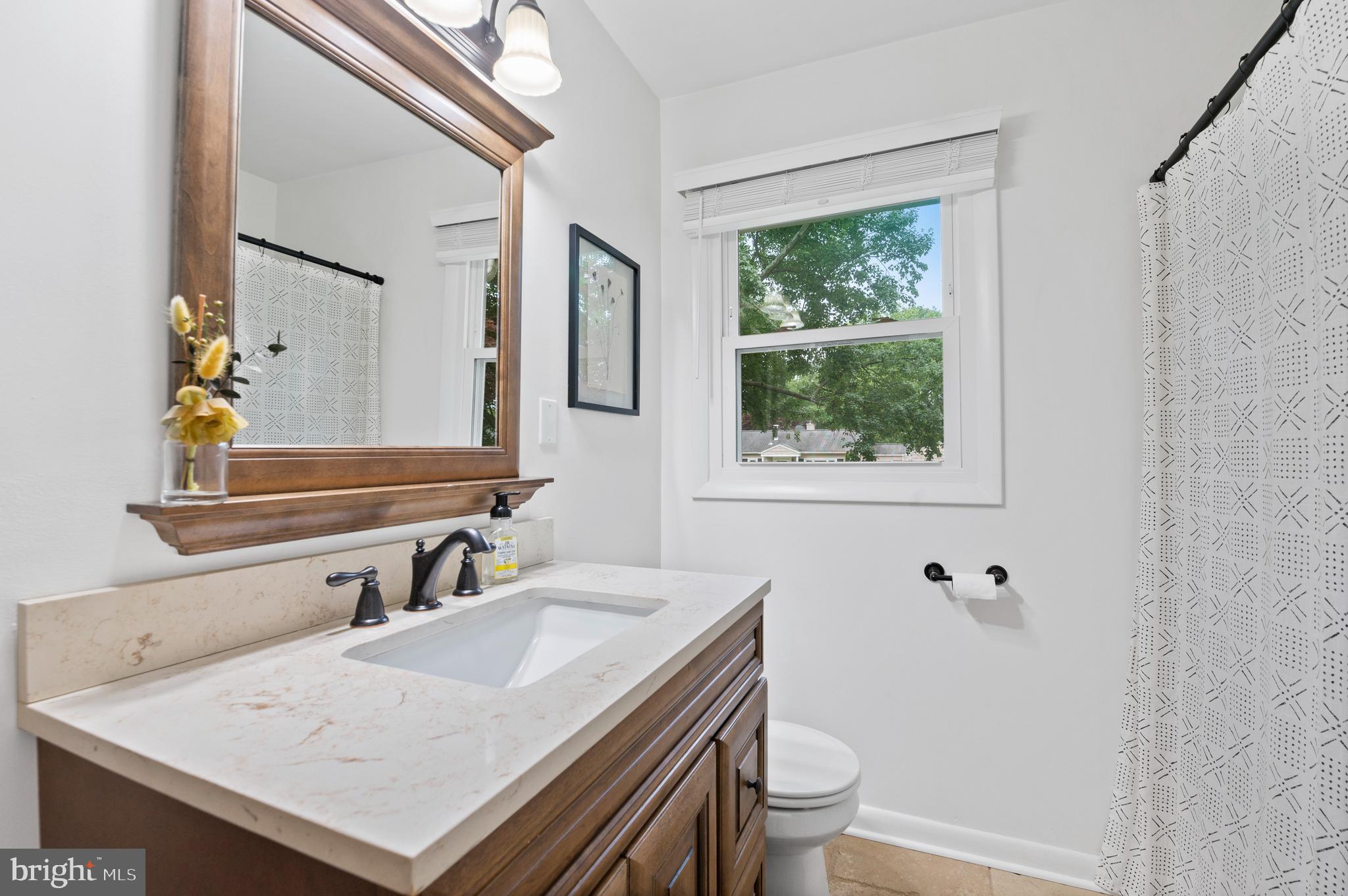 105 Manor Road Paoli, PA 19301 - Photo 18 of 30 a bathroom with a sink a toilet and a mirror