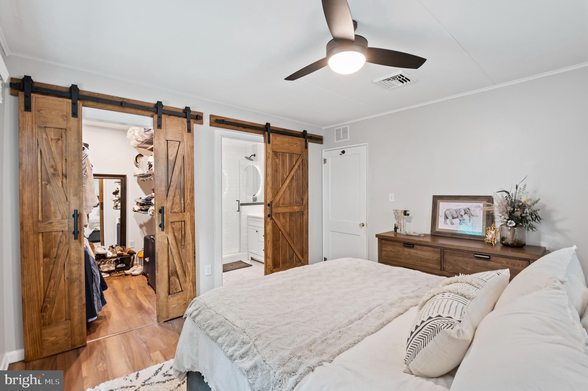 105 Manor Road Paoli, PA 19301 - Photo 21 of 30 a bedroom with a bed and a chandelier