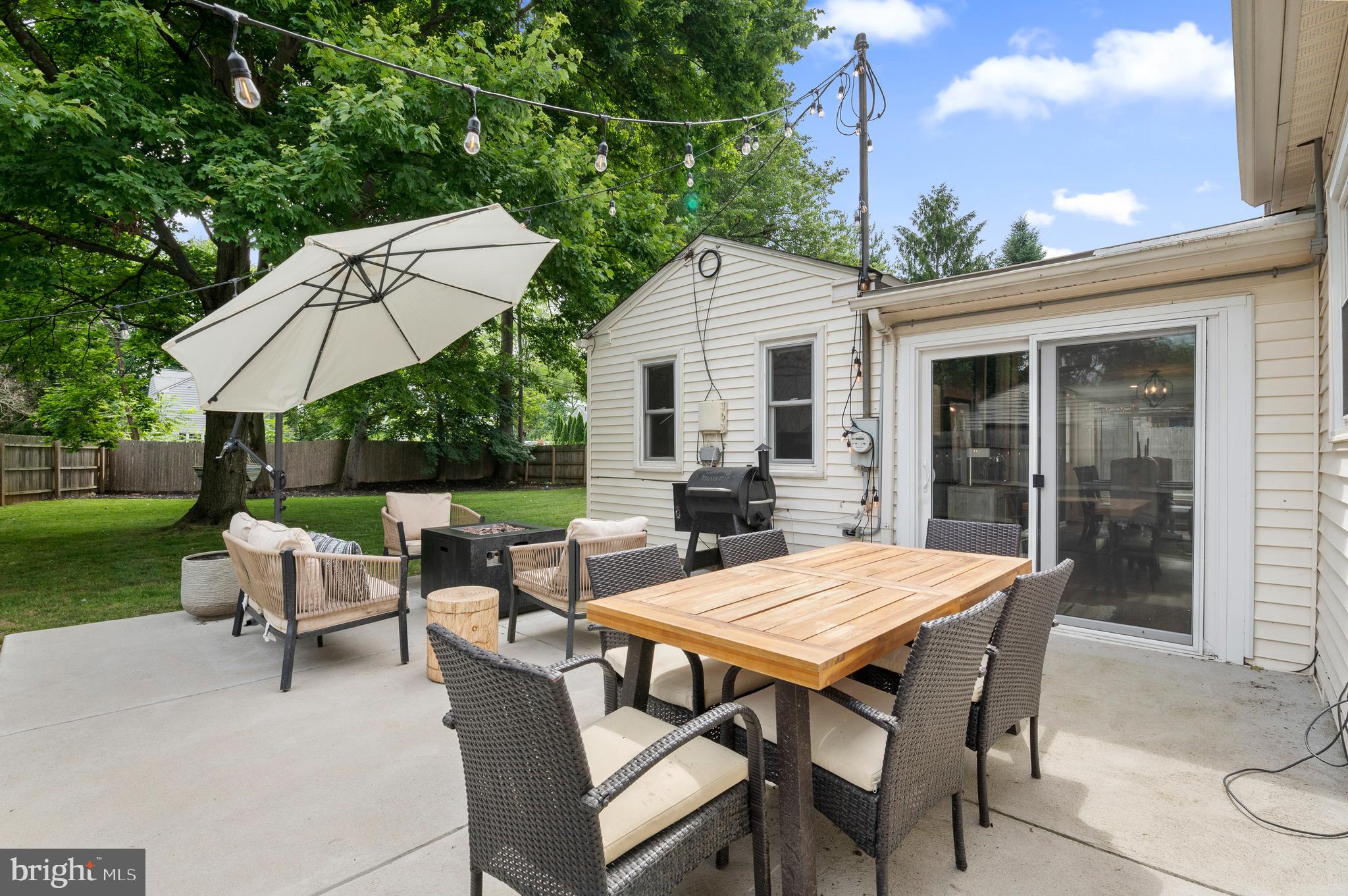 105 Manor Road Paoli, PA 19301 - Photo 26 of 30 a view of a patio with a table chairs and a fire pit