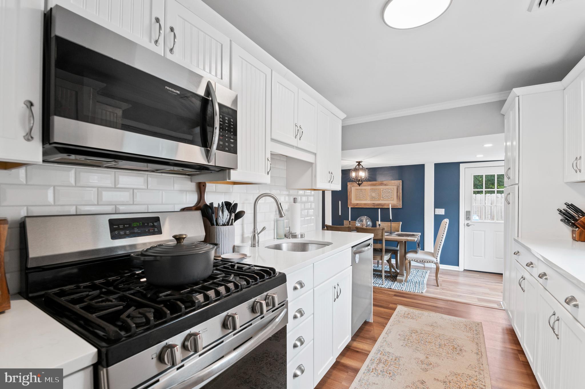 105 Manor Road Paoli, PA 19301 - Photo 7 of 30 a kitchen with stainless steel appliances a sink a stove and cabinets