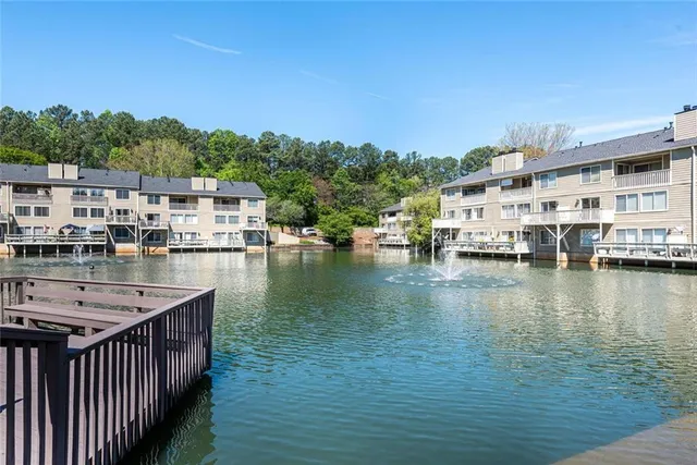a view of a lake with houses in the background