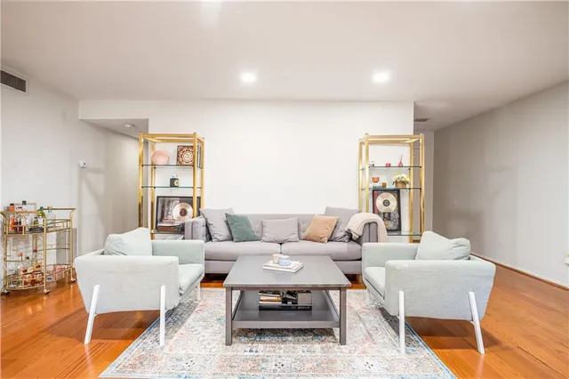 a living room with furniture a rug and a table