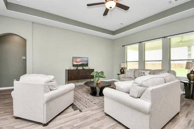 a living room with furniture and a large window