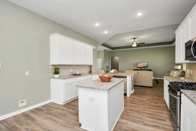 a kitchen with a sink stove and cabinets