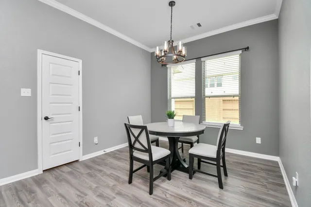 a view of a dining room with furniture and window