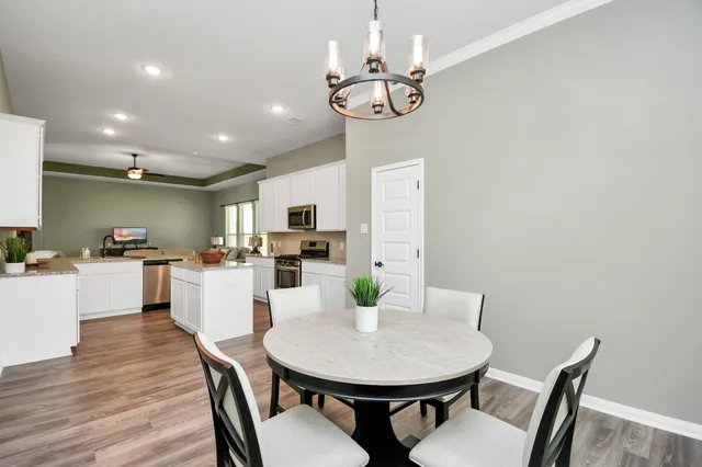a view of a dining room with furniture and wooden floor