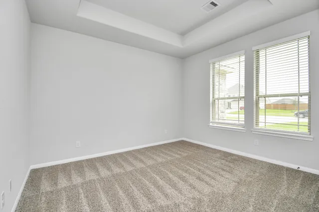 an empty room with closet and natural light