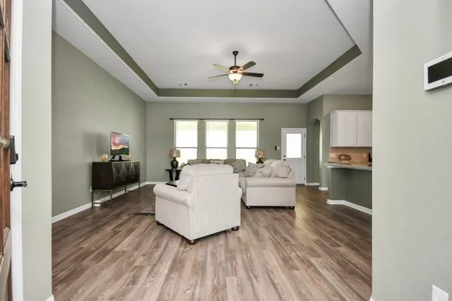 a living room with furniture and a chandelier