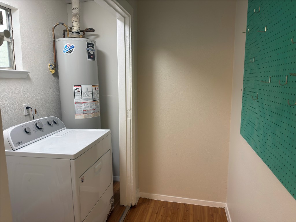 115 Waller Street, Unit A Austin, TX 78702 - Photo 16 of 18 Washroom featuring washer / dryer, gas water heater, and light wood finished floors