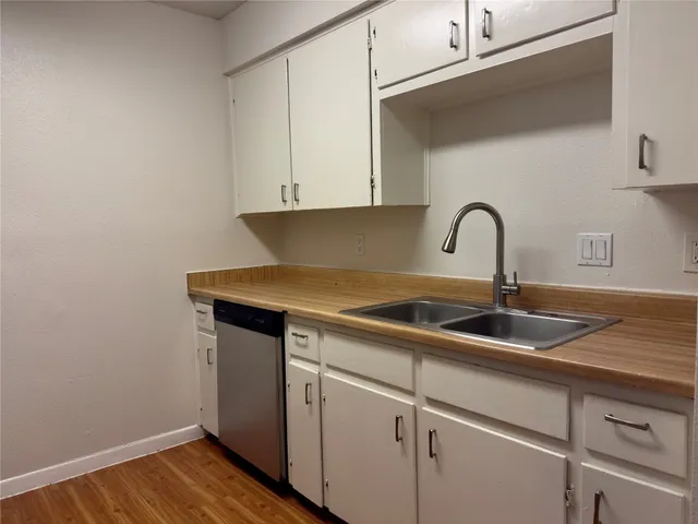 a close view of a sink and cabinets