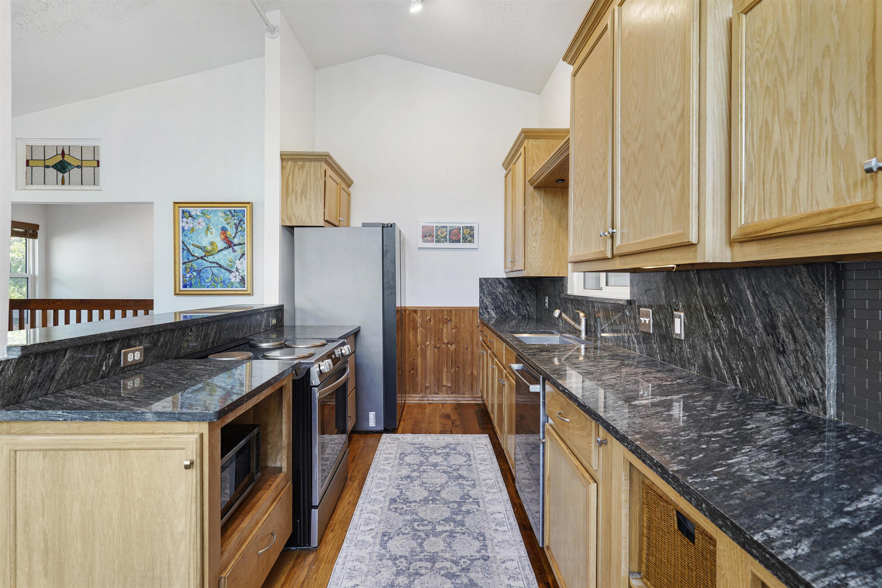 415 Fifteenth Street St. Augustine, FL 32084 - Photo 12 of 41 a kitchen with granite countertop a sink and a stove
