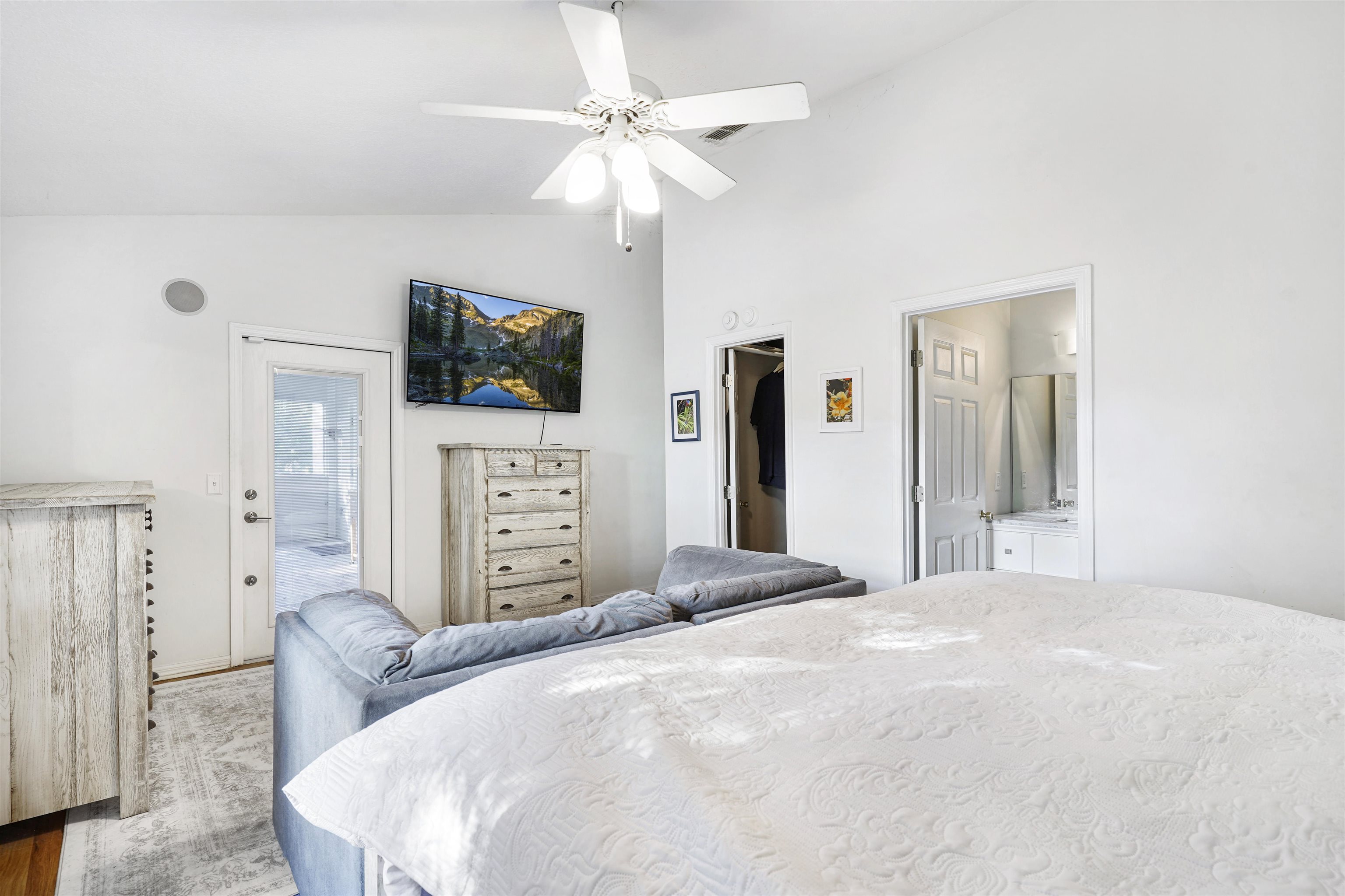 415 Fifteenth Street St. Augustine, FL 32084 - Photo 17 of 41 a bedroom with a bed a flat screen tv and a chandelier