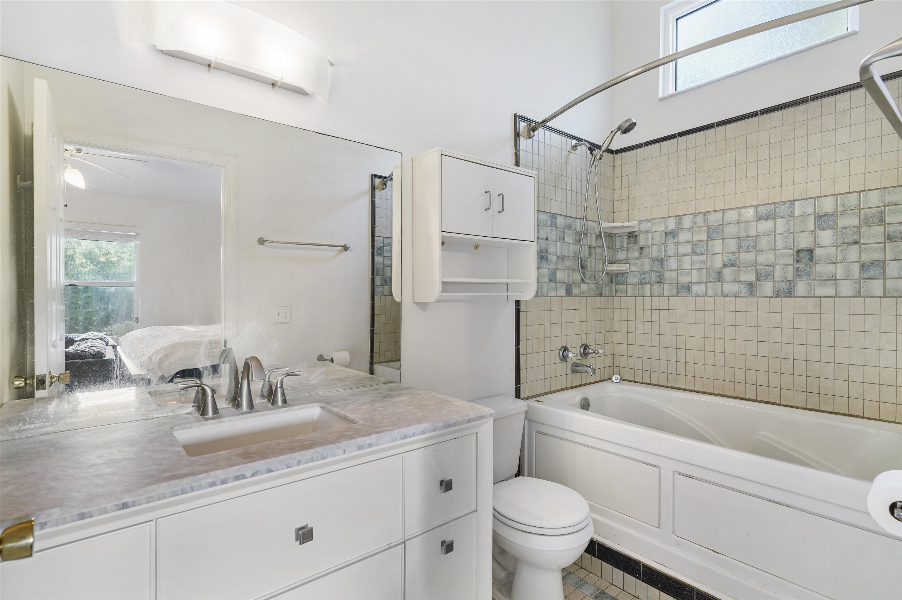 415 Fifteenth Street St. Augustine, FL 32084 - Photo 18 of 41 a bathroom with a granite countertop sink a toilet and shower