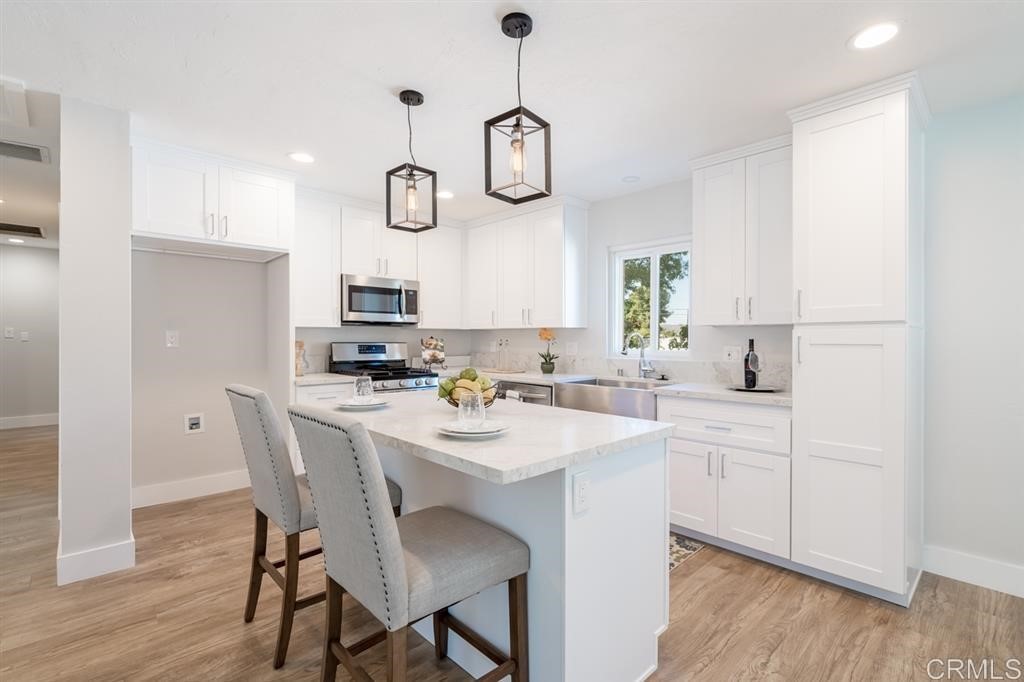 8572 Rhone Road Santee, CA 92071 - Photo 1 of 1 a kitchen with a table and chairs in it