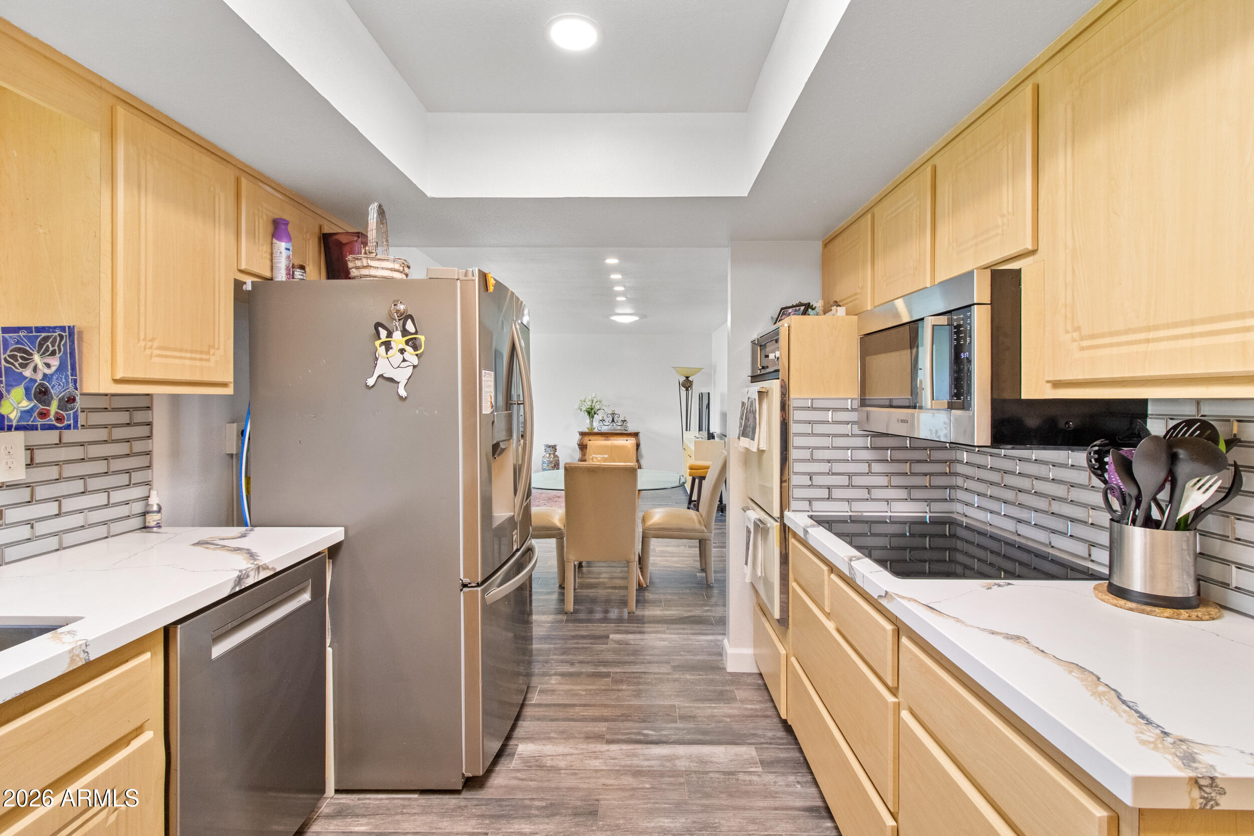 9801 West Pleasant Valley Road Sun City, AZ 85351 - Photo 13 of 26 a kitchen with refrigerator and cabinets