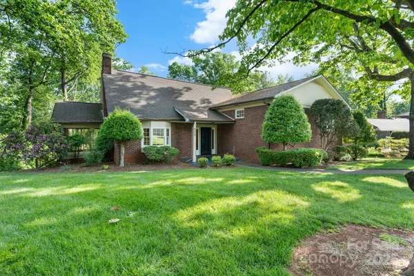 a view of a house with yard and a garden
