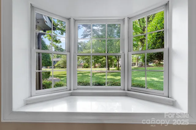 a white bath tub sitting in front of a window