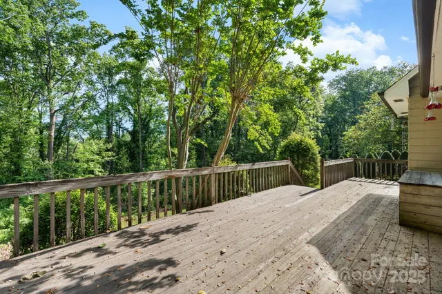 a view of balcony with deck and yard