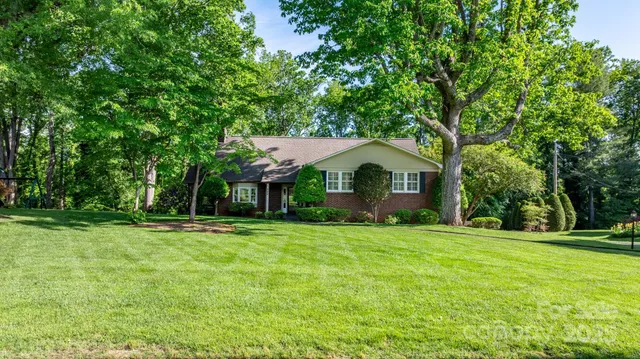 a front view of a house with a yard and trees