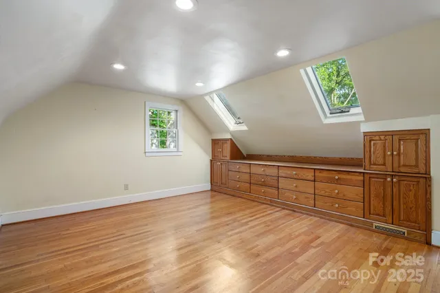 a view of an empty room with window and cabinet