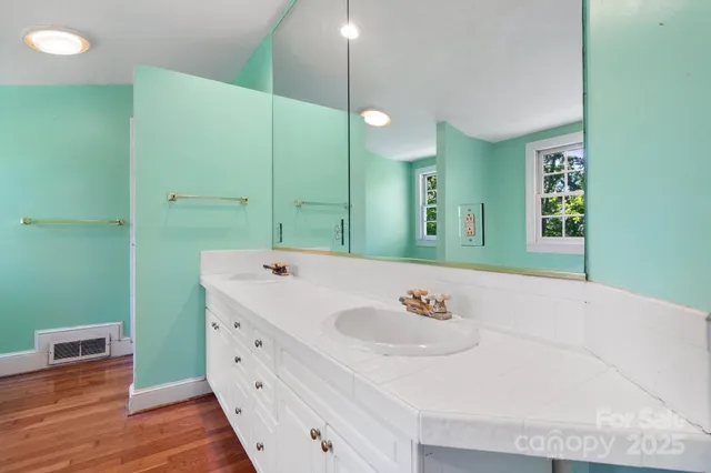 a bathroom with a sink a mirror and a toilet