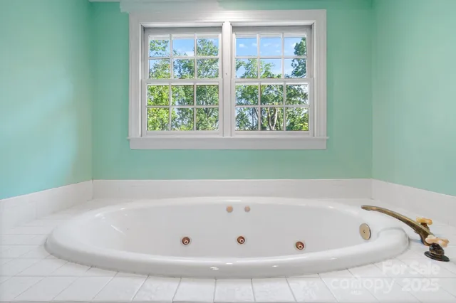 a bath tub sitting in a bathroom next to a window