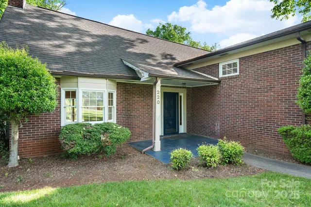 a view of a house with a yard and plants